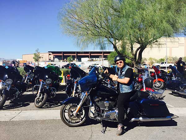 Beijing resident Zhao Yang poses for a photo with his Harley Davidson motorcycle in Las Vegas, the United States, before embarking on a riding tour in October last year.Xu Yana / For China Daily
