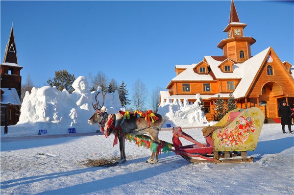 A reindeer-drawn sleigh in front of the Santa's house in Santa Village in China's northernmost county Mohe, Heilongjiang province. (Photo By Liu Xiangrui / China Daily)