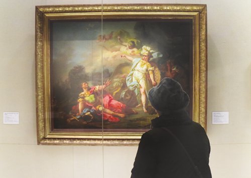 A woman views The Combat of Mars and Minerva at the Louvre exhibition in the National Museum of China on Friday. (Photo: Huang Tingting/GT)