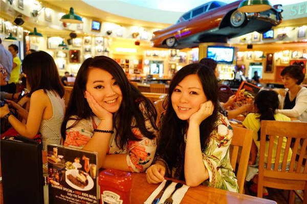 Baozou Sisters Zhang Jin (left) and Pang Qianyi rest at the Hard Rock cafe in Saipan.