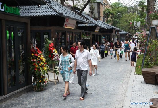 People walk on the first book street in Hanoi, Vietnam, on May 1, 2017. (Xinhua/Tran Nguyen Duc)