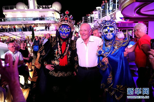 Sichuan opera performers pose with a passenger on cruise ship Majestic Princess, June 19, 2017. (Photo/Xinhua)