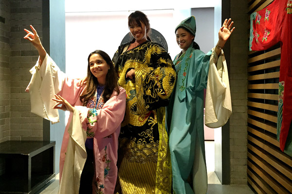 Some foreign students dress in traditional Chinese clothing during the trip. (Photo by Yang Feiyue/China Daily)