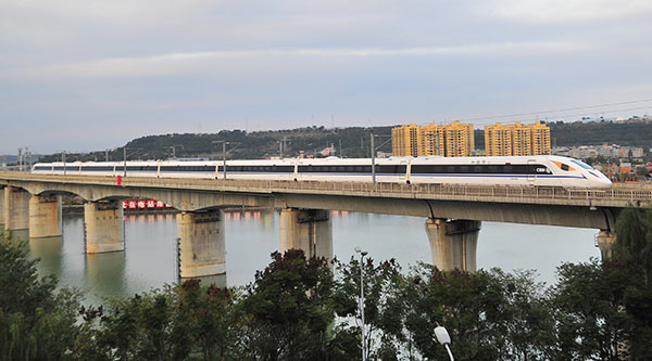 A bullet train passes through Mianyang, Sichuan province, during a trial run on Tuesday. The Xi'an-Chengdu High-Speed Railway is expected to formally open next week. CAO NING/FOR CHINA DAILY