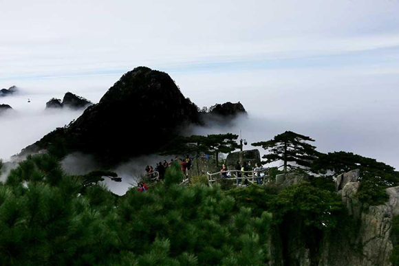 Mist shrouds the Mount Huangshan scenic area in Auhui Province on Oct. 18, 2017. Mountain peaks appear partly hidden after a recent rainfall. (Photo/Asianewsphoto)