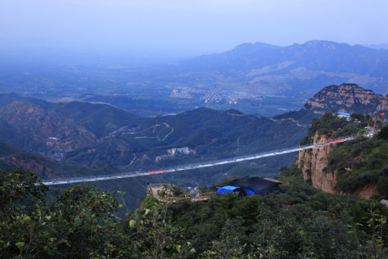 An aerial view of the world's longest glass-floor bridge in the Hongyagu Scenic Area in Hebei province. [Photo provided to China Daily]