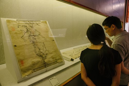 Visitors look at ancient maps of the Tongzhou district waterways at Beijing's Capital Museum on Wednesday. (Photo: Li Hao/GT)