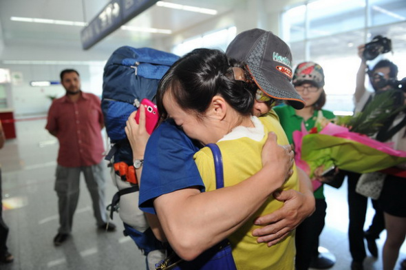 Zhang Jingchuan (left, front), the only survivor of a four-member Chinese amateur mountaineering team following an Taliban terrorist attack in northern Pakistan on Sunday, returns to China at an airport in Urumqi, Northwest China's Xinjiang autonomous region, June 25, 2013. Two Chinese civilian mountaineers and a Chinese American were among the 11 people killed in a pre-dawn terrorist attack in Pakistan-administered Kashmir on Sunday. [Photo by Zhang Wande/Asianewsphoto]