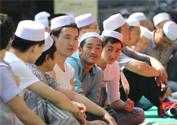 Muslims attend the Eid Al-Fitr prayer at Niujie Mosque in Beijing on Aug 8, 2013. The three-day festival marks the end of Ramadan, Islam's holy month of fasting.[Zou Hong/Asianewsphoto]