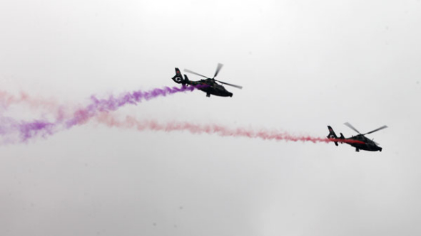 Two helicopters perform during the Second China Helicopter Exposition in the northern city of Tianjin, Sept 5, 2013. [Photo/Asianewsphoto]