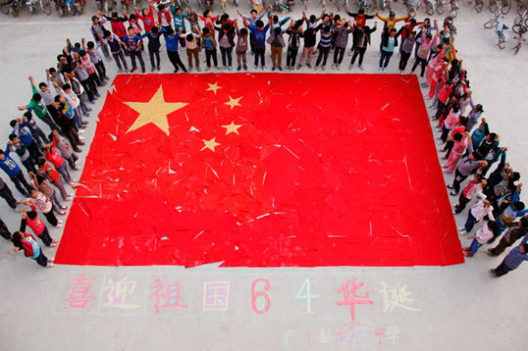 Students celebrate after making a national flag with red scarves to celebrate National Day that is on on Oct 1, in Guangping county, North China's Hebei province, Sept 27, 2013. October 1 marks the 64th anniversary of the founding of the People's Republic of China. [Photo/Asianewsphoto]