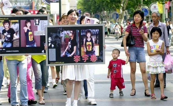 In August 2005, fans in Hangzhou, capital of East China's Zhejiang province, hold up posters of singer Li Yuchun. [Photo/Xinhua]