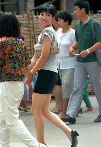 File photo taken in September of 1991 shows a girl wearing mini skirt walking on a street in Dalian City, northeast China's Liaoning province.