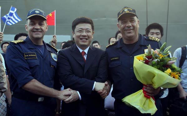 Chinese Ambassador to Greece Zou Xiaoli (C) shakes hands with captains of Frigate Salamis at Piraeus port, Greece, on Aug 2, 2014. Greek frigate Salamis with Greeks and foreign nationals evacuated from violence-hit Libya on board reached Piraeus port on Saturday. [Photo/Xinhua]