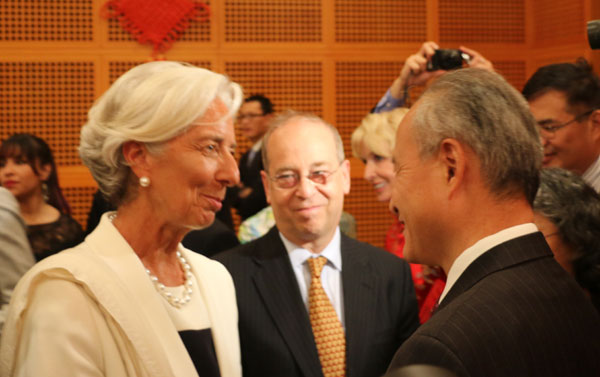 Chinese Ambassador to the US Cui Tiankai (right) chats with Christine Lagard (left), manager director of the International Monetary Fund, while US Assistant Secretary of State for East Asian and Pacific Affairs Daniel Russel looks on, at a reception in the Chinese embassy in Washington on Monday evening to mark the 65th anniversary of the founding of the People's Republic of China. Chen Weihua/China Daily