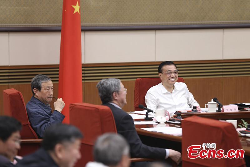 Li presides over symposium with representatives from financial enterprises