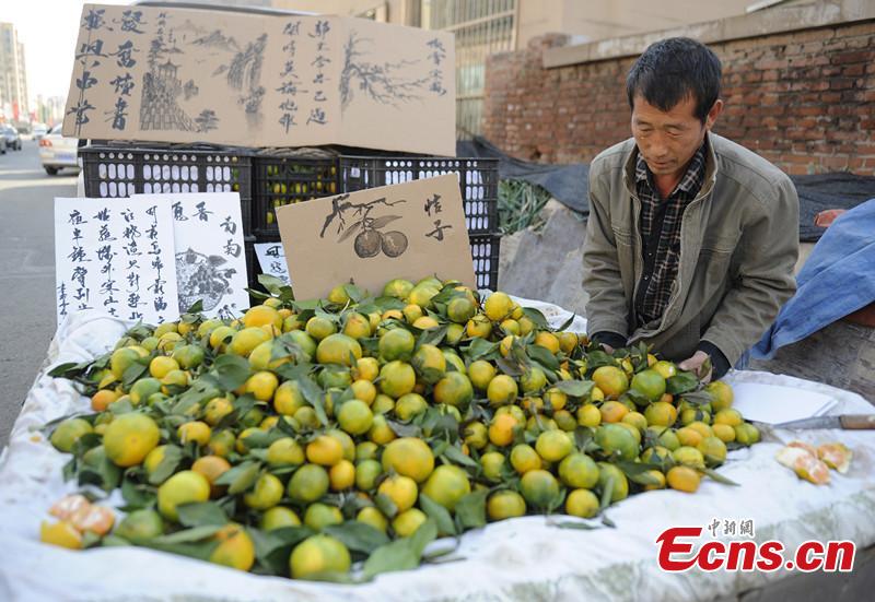 Vendor draws fruits to attract customers
