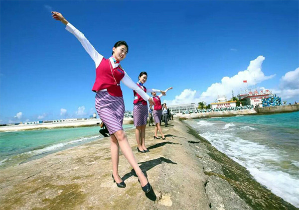 Stewardesses celebrate after China successfully carried out test flights of two commercial airliners on Jan 6 at a newly built airport at Yongshu Jiao in China's Nansha Islands.  (Photo/Xinhua)