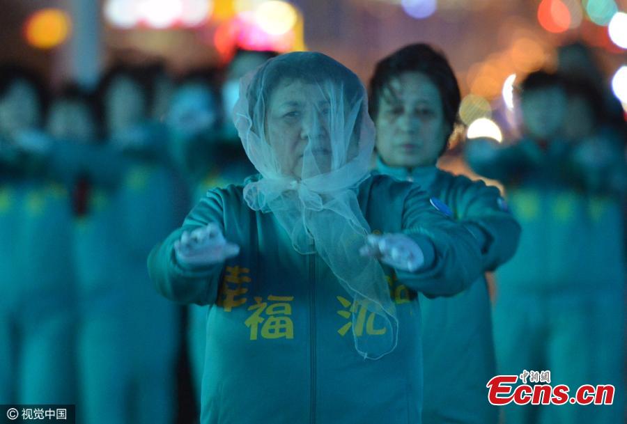 Women exercise despite strong wind