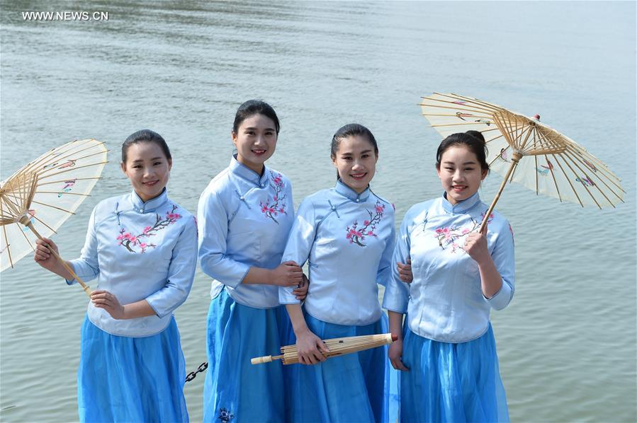 Service staff present workwear at fashion show in E China's ancient town 