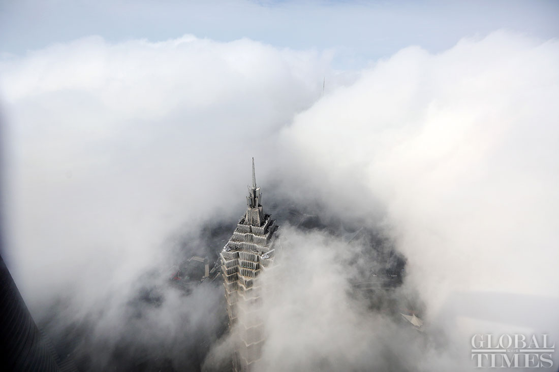 Skyscrapers shrouded in advection fog in Shanghai