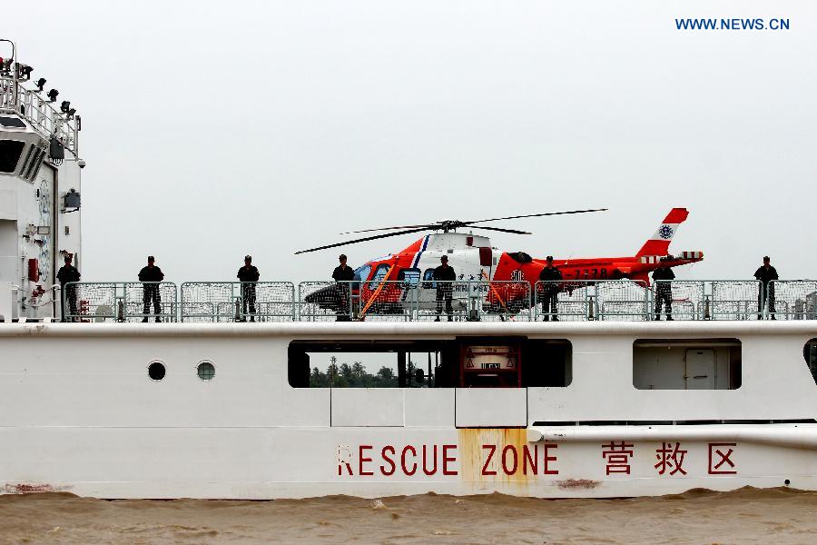 Crew members stand on the deck of Chinese search and rescue vessel \