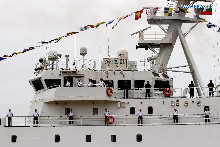 Crew members stand on the deck of Chinese search and rescue vessel \