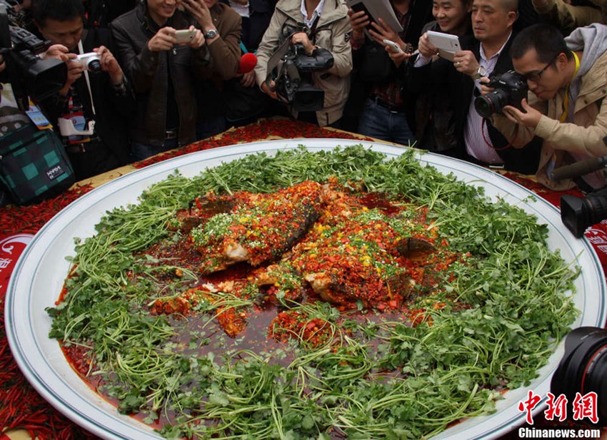 
People take photo of a giant dish of \
