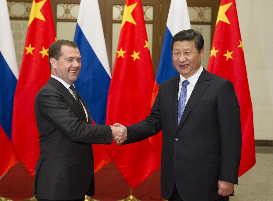 
Chinese President Xi Jinping (R) shakes hands with Russian Prime Minister Dmitry Medvedev during their meeting in Beijing, capital of China, Oct. 22, 2013. (Xinhua/Huang Jingwen)