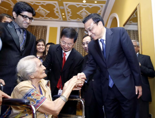 Chinese Premier Li Keqiang (1st R, front) meets with Dr. Dwarkanath Kotnis' younger sister Manorama (L, front) and other relatives in Mumbai, India, May 21, 2013. Li Keqiang called here on Tuesday for efforts to carry on China-India traditional friendship as he paid tribute to Dr. Kotnis who died while treating Chinese troops more than 70 years ago. (Xinhua/Ju Peng)
