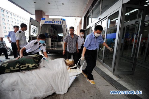 A person injured in a fire accident at a poultry slaughterhouse in Dehui is wheeled to a hospital in Changchun, capital of northeast China's Jilin Province, June 3, 2013. The cause of the fire is under investigation. (Xinhua/Zhang Nan)