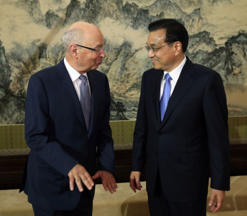 Premier Li Keqiang meets Klaus Schwab, executive chairman of the World Economic Forum, in Beijing on Friday. PHOTO BY WU ZHIYI / CHINA DAILY