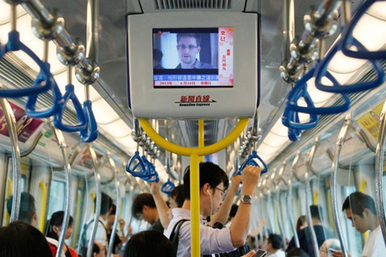 An interview with Edward Snowden, a former CIA employee who leaked top-secret information about sweeping US surveillance programs, is shown in a subway car in Hong Kong on Sunday. Kin Cheung / Associated Press  