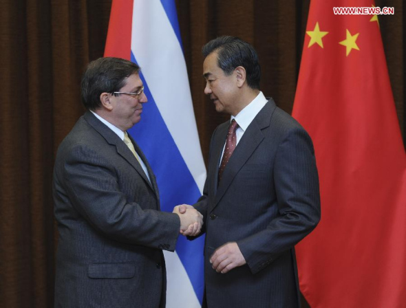 Chinese Foreign Minister Wang Yi (R) shakes hands with his Cuban counterpart Bruno Rodriguez on his official visit in Beijing, capital of China, Nov. 6, 2013. (Xinhua/Zhang Duo)