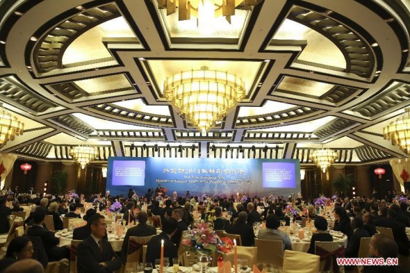 Guests attend the New Year Reception 2014 hosted by the Ministry of Foreign Affairs of China, in Beijing, capital of China, Dec. 11, 2013. More than 400 guests, including Chinese State Councilor Yang Jiechi, attended the reception on Wednesday. (Xinhua/Ding Lin) 