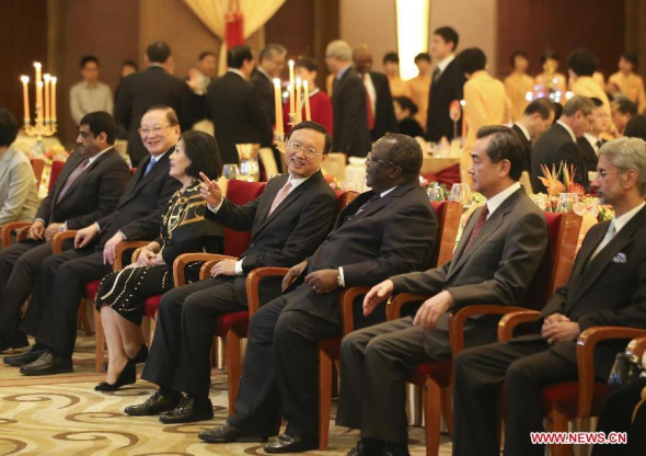 Chinese State Councilor Yang Jiechi (4th R, front) talks with guests at the New Year Reception 2014 hosted by the Ministry of Foreign Affairs of China, in Beijing, capital of China, Dec. 11, 2013. More than 400 guests, including Chinese State Councilor Yang Jiechi, attended the reception on Wednesday. (Xinhua/Ding Lin)