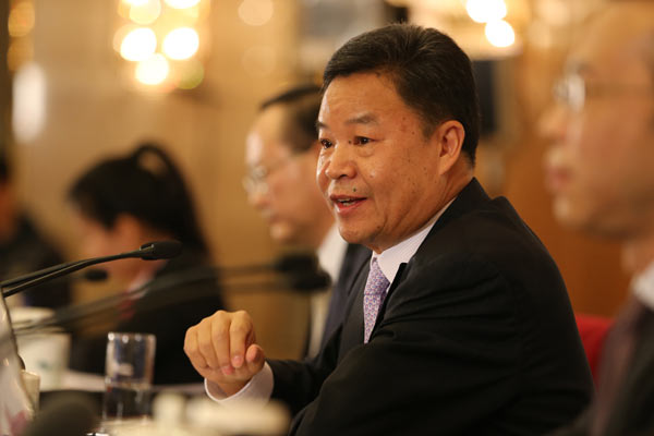 Lyu Xinhua, spokesman for the second session of the 12th National Committee of the Chinese People's Political Consultative Conference (CPPCC) answers questions from the press in Beijing March 2, 2014. [Photo by Jiang Dong/China Daily]