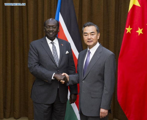 Chinese Foreign Minister Wang Yi (R) shakes hands with South Sudanese Foreign Minister Barnaba Marial Benjamin in Beijing, China, Aug 19, 2014. (Xinhua/Wang Ye)