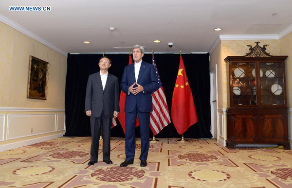 Chinese State Councillor Yang Jiechi (L) and US Secretary of State John Kerry speak to reporters prior to a meeting in Boston, Massachusetts, the United States, Oct. 18, 2014.  (Xinhua/Yin Bogu)