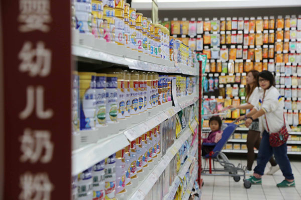 Dairy products at a supermarket in Xuchang, Henan province. The government's stricter permit requirements, which are expected to keep up to one-third of domestic infant formula producers from manufacturing, is driving up competition between local and foreign dairy brands. Geng Guoqing / For China Daily