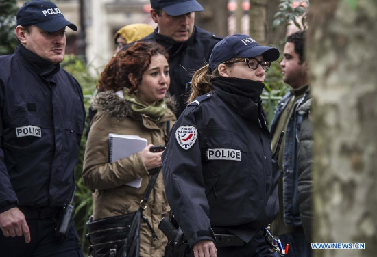 French police officers stand guard near the Paris office of Charlie Hebdo in Paris, France, Jan. 7, 2015. The office of Paris Prosecutor of the Republic confirmed at least 12 people were killed on Wednesday in a shooting at the Paris office of Charlie Hebdo, a satirical newspaper, adding four others were seriously wounded in the terror attack. (Xinhua/Chen Xiaowei)  