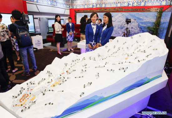 Visitors view sandbox models at the expo of Beijing Candidate City's bid for the 2022 Winter Olympic games at the Palace hotel in Lausanne, Switzerland, on June 10, 2015. (Photo: Xinhua/Zhou Lei)