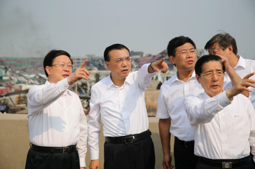 Premier Li Keqiang makes an inspection visit on Sunday to the scene of last week's explosions in Tianjin Port. (Liu Zhen/China News Service)