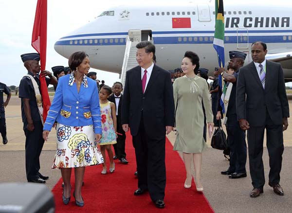 Chinese President Xi Jinping (2nd L, front) and his wife Peng Liyuan (2nd R, front) are welcomed by South Africa's International Relations and Cooperation Minister Maite Nkoana-Mashabane upon their arrival in Pretoria, South Africa, Dec 2, 2015. Xi arrived here on Wednesday for a state visit to South Africa. (Photo/Xinhua)