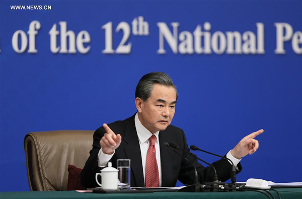 Chinese Foreign Minister Wang Yi gestures at a press conference on the sidelines of the fourth session of China's 12th National People's Congress in Beijing, capital of China, March 8, 2016. Wang talked about China's foreign policy on international and regional issues. (Photo: Xinhua/Chen Junqing)