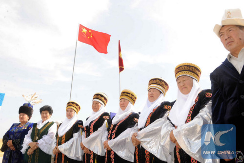 People dressed in traditional Kyrgyz clothes attend the commencement ceremony at the construction site of the Datka substation in the Bazar-Korgon district of the Jalal-Abad region in Kyrgyzstan, July 28, 2011. With a capacity of 500 kilovolts, the substation is financed by preferential export buyer's credit extended by China. The total amount of the agreement is $208 million. This project was designed to address the power supply imbalance and the transmission bottleneck in southern Kyrgyzstan. (Xinhua/Sadat)