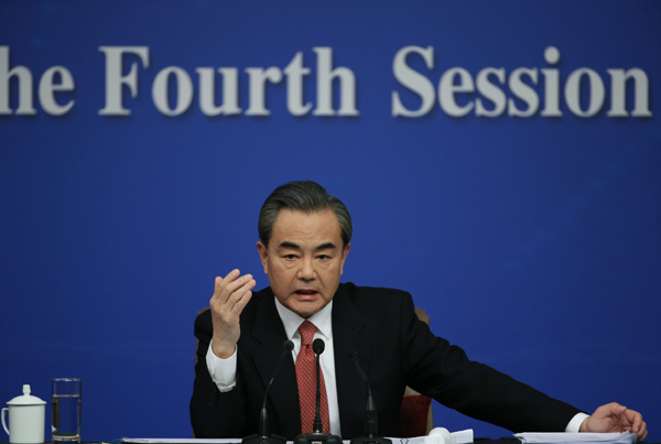 Chinese Foreign Minister Wang Yi takes questions from the press during a news conference on the sidelines of the two sessions on March 8. (Photo by Kuang Linhua/chinadaily.com.cn)