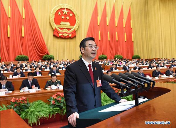 Zhou Qiang, president of the Supreme People's Court (SPC), delivers a report on the SPC's work during the third plenary meeting of the fourth session of China's 12th National People's Congress at the Great Hall of the People in Beijing, capital of China, March 13, 2016. (Photo/Xinhua)