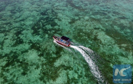 A boat moves on the sea near Zhaoshu Island of Qilianyu Islands in Sansha City, south China's Hainan Province, April 30, 2016. (Photo: Xinhua/Yang Guanyu)