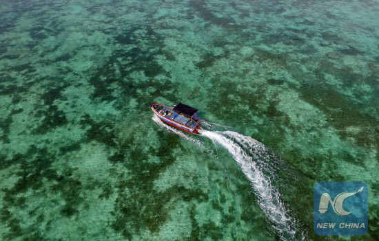 A boat moves on the sea near Zhaoshu Island of Qilianyu Islands in Sansha City, south China's Hainan Province, April 30, 2016. (Xinhua/Yang Guanyu)